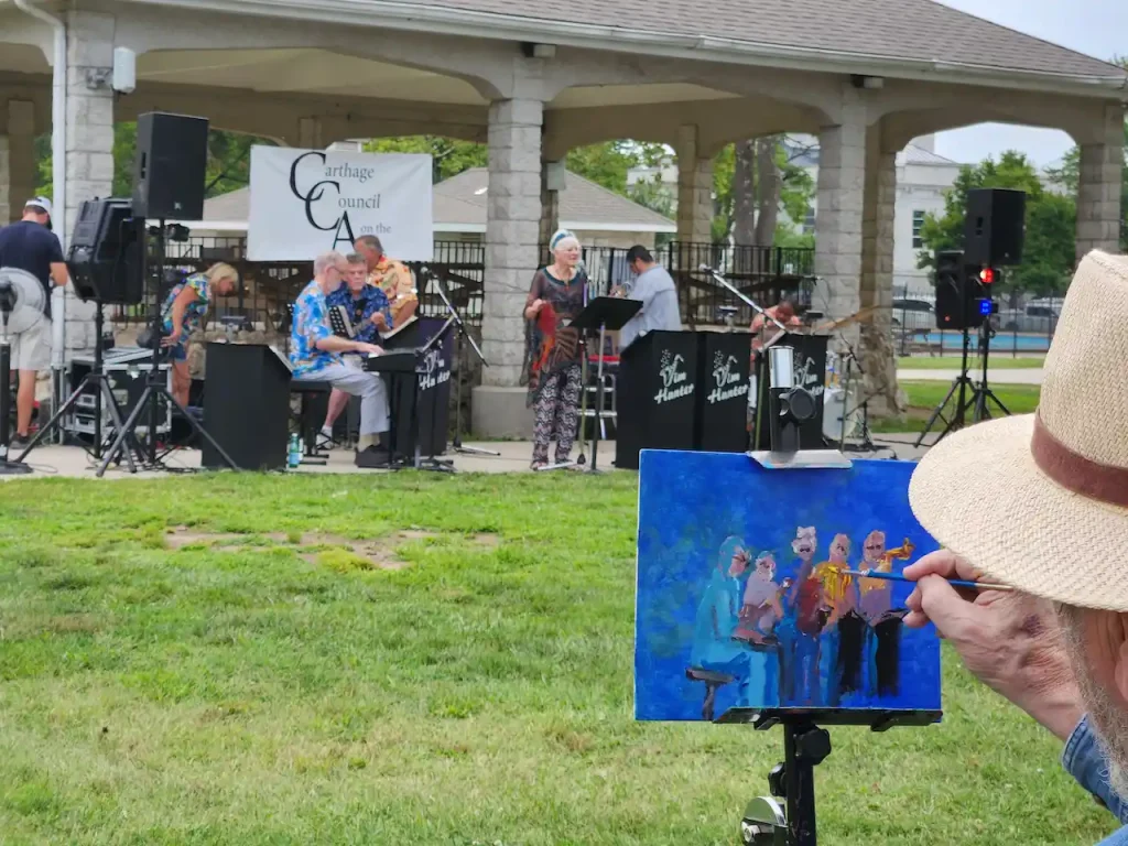Artist painting band performing in park pavilion